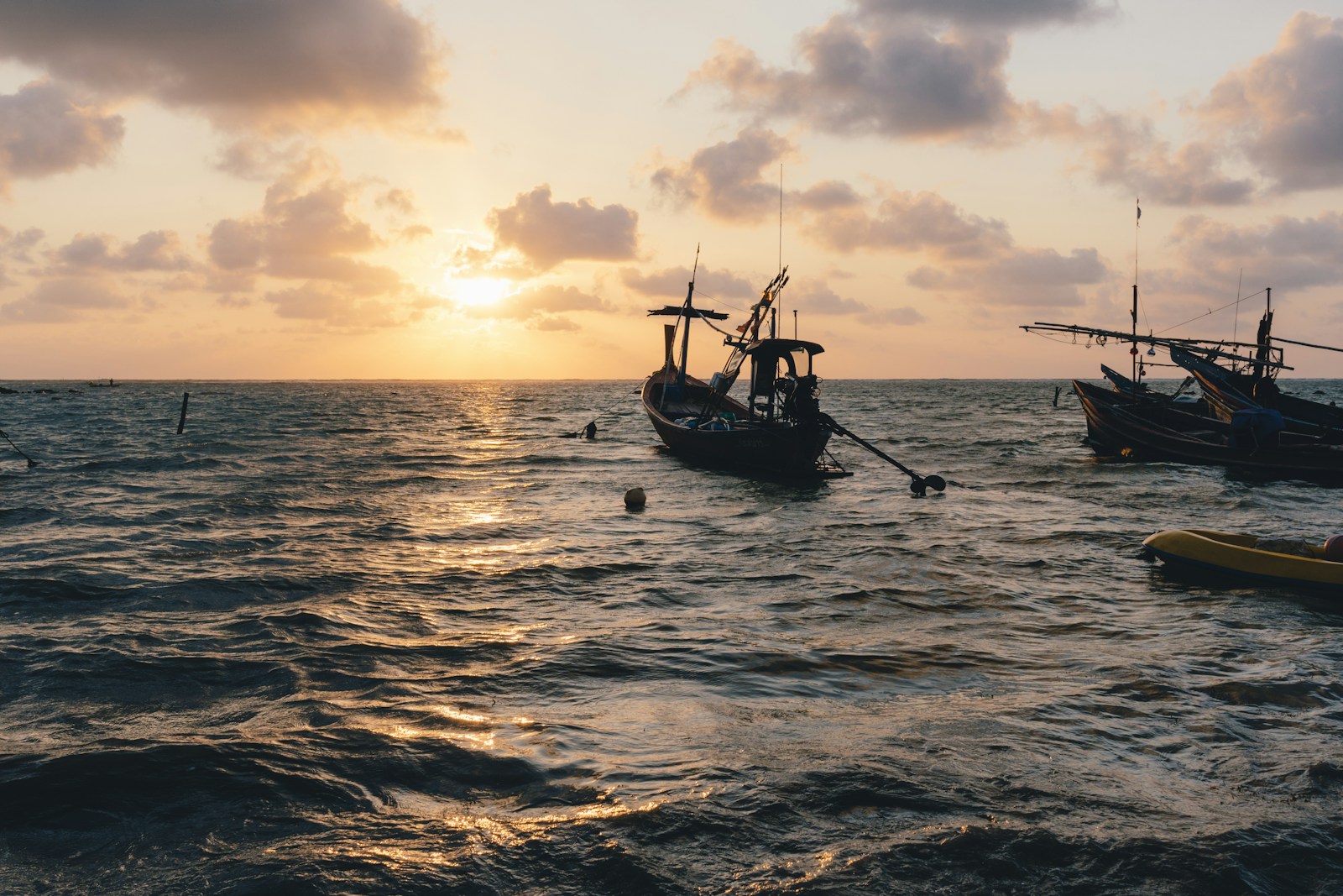 several boat on body of water during sunset